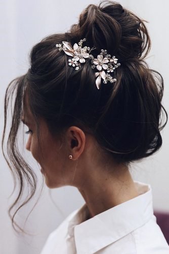elegant wedding hairstyles textured high bun with silver flower pin tonyastylist
